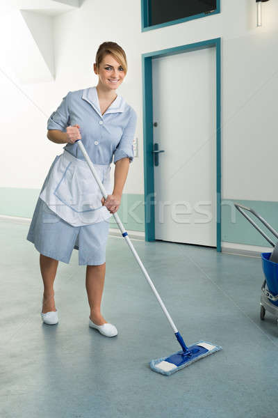 Happy Female Janitor Holding Mop Stock photo © AndreyPopov