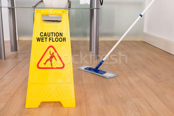 Wet Floor Sign And Mop Stock photo © AndreyPopov