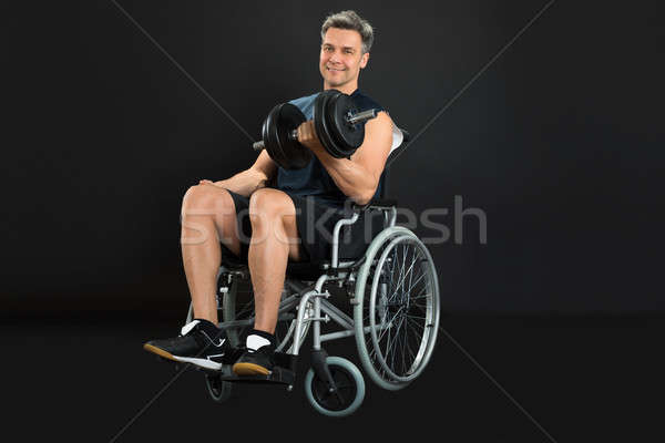 Behindert Mann Rollstuhl Hantel schwarz Stock foto © AndreyPopov