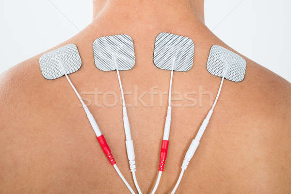 Man With Electrodes On His Back Stock photo © AndreyPopov