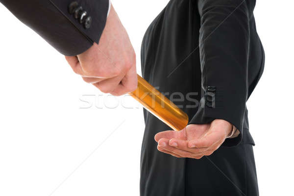 Person Passing A Golden Relay Baton To Another Person Stock photo © AndreyPopov
