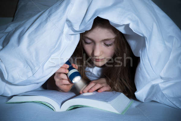 Girl Reading Book With Flashlight Stock photo © AndreyPopov