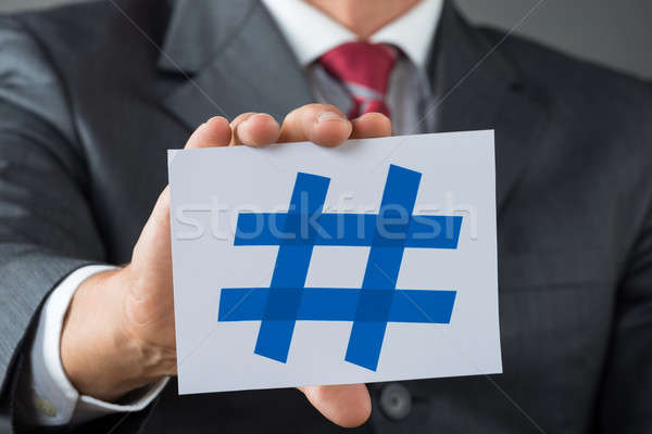 Businessman Showing Hash Sign At Desk Stock photo © AndreyPopov