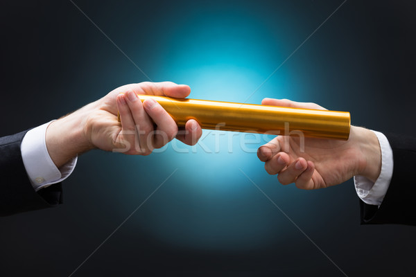 Businessman Passing Relay Baton To Colleague Stock photo © AndreyPopov