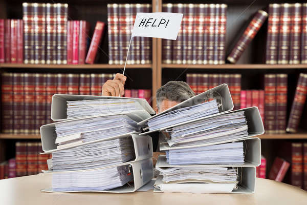 Accountant Holding Help Flag Between The Stacked Folders Stock photo © AndreyPopov