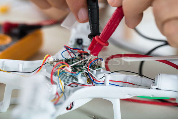 Man Testing Electric Current Of Drone Using Multimeter Tool Stock photo © AndreyPopov