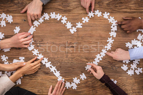 Businesspeople Forming Heart Shape With Jigsaw Puzzle Stock photo © AndreyPopov