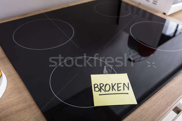 Induction Stove With Adhesive Notes Showing Broken Text Stock photo © AndreyPopov