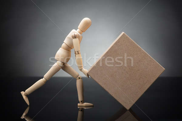 Wooden Dummy Lifting Cardboard Box Stock photo © AndreyPopov