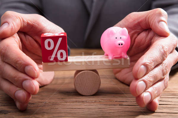 Human Hand Protecting Balance Between Percentage And Piggybank Stock photo © AndreyPopov