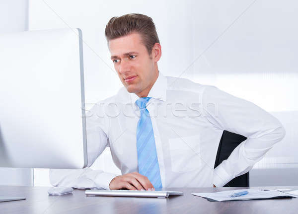Businessman Suffering From Back Ache Stock photo © AndreyPopov