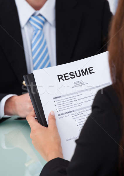 Female Candidate Holding Resume At Desk Stock photo © AndreyPopov