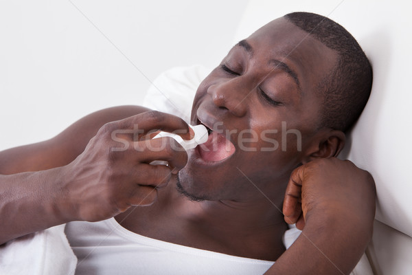 African Man Using Asthma Inhaler Stock photo © AndreyPopov
