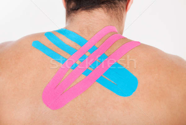 Young Man With Physio Tape Applied On Back Stock photo © AndreyPopov