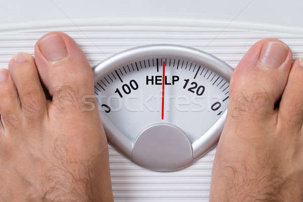 Man's Feet On Weight Scale Indicating Help Stock photo © AndreyPopov