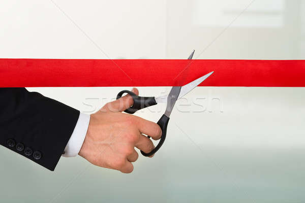 Businessman Cutting Red Ribbon With Scissors Stock photo © AndreyPopov