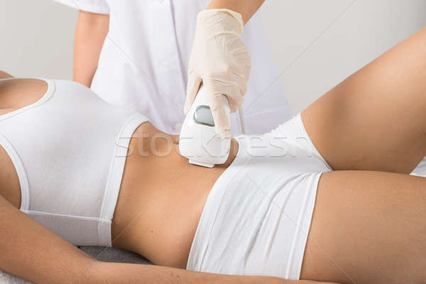 Mujer láser tratamiento vientre primer plano belleza Foto stock © AndreyPopov