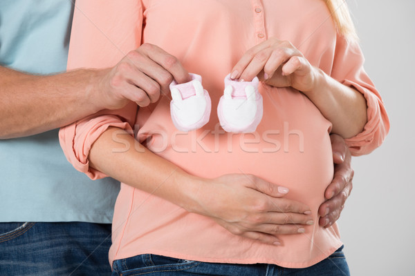 Expecting Couple Holding Baby Shoes Stock photo © AndreyPopov