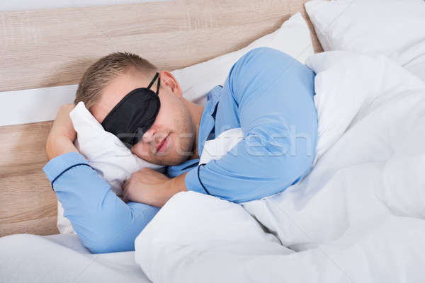 Man Sleeping On Bed Stock photo © AndreyPopov