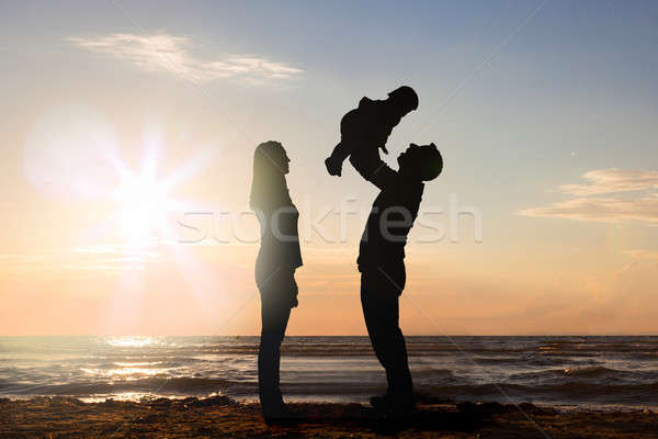 Woman Looking At Man Carrying His Child Stock photo © AndreyPopov