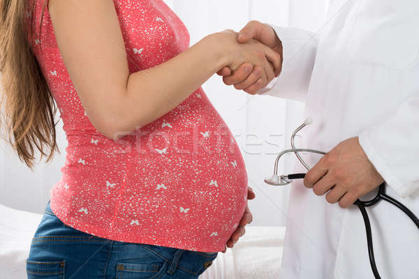 Pregnant Woman Shaking Hands With Doctor Stock photo © AndreyPopov