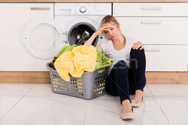Esgotado mulher sessão máquina de lavar roupa mulher jovem cesta Foto stock © AndreyPopov
