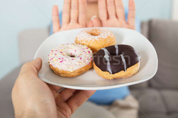 Woman Rejecting Doughnuts Stock photo © AndreyPopov
