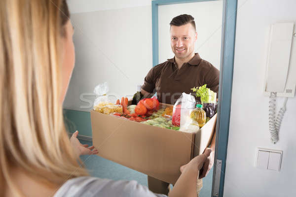 Delivery Man Holding Groceries Stock photo © AndreyPopov