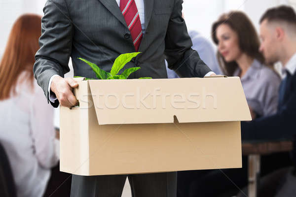 Businessperson Holding Belongings In Cardboard Box Stock photo © AndreyPopov