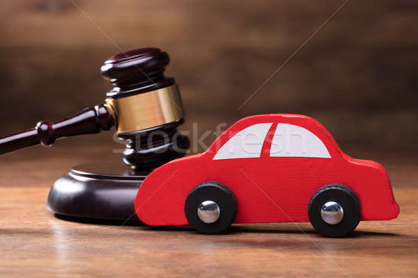 Wooden Toy Red Car In Front Of Gavel Stock photo © AndreyPopov