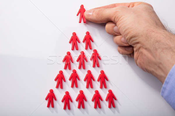 Red Human Figures Arranged In Triangular Shape Stock photo © AndreyPopov