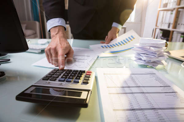 Businessperson Calculating Invoice Stock photo © AndreyPopov