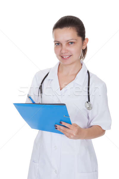 Cheerful young nurse writing a report Stock photo © AndreyPopov