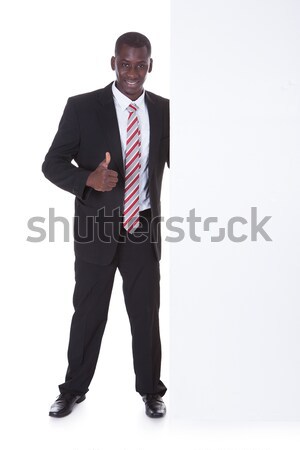 African Businessman Holding Placard Stock photo © AndreyPopov