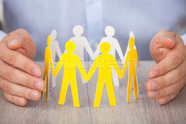 Hands Protecting Team Of Paper People Stock photo © AndreyPopov