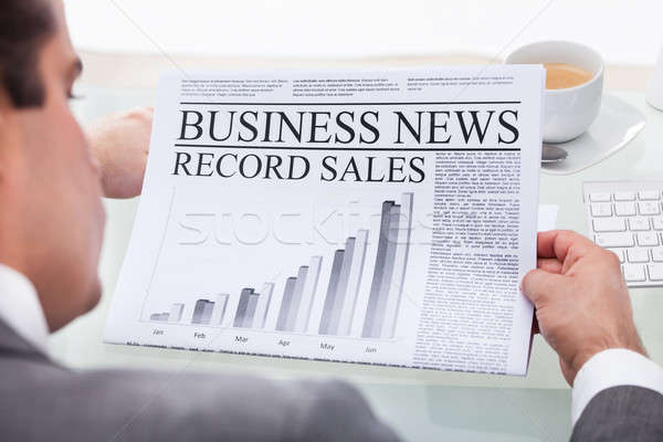 Stock photo: Young Businessman Reading News On Newspaper