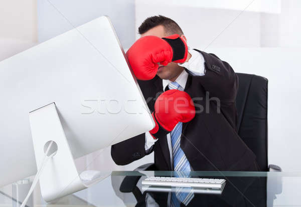 Stock photo: Angry Businessman Hitting Computer With Boxing Gloves