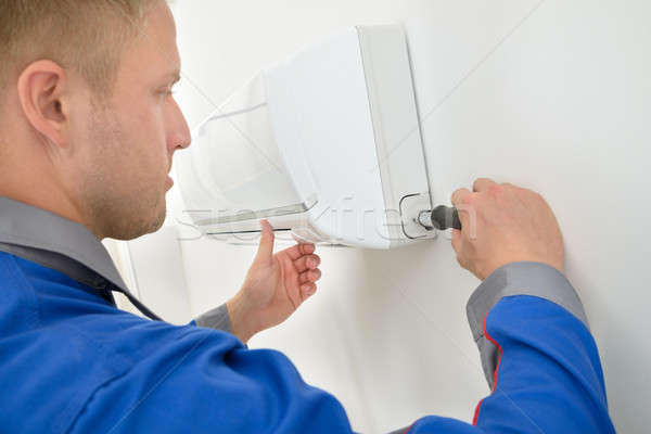 Stock photo: Technician Repairing Air Conditioner