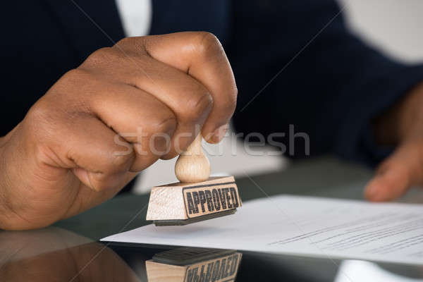 Person's Hand Stamping On Contract Form Stock photo © AndreyPopov
