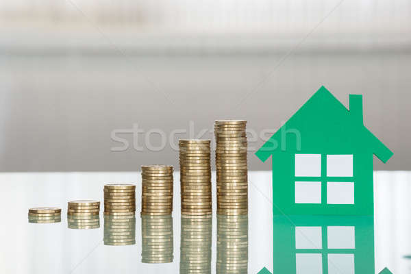 House Model With Stacked Coins On Desk Stock photo © AndreyPopov