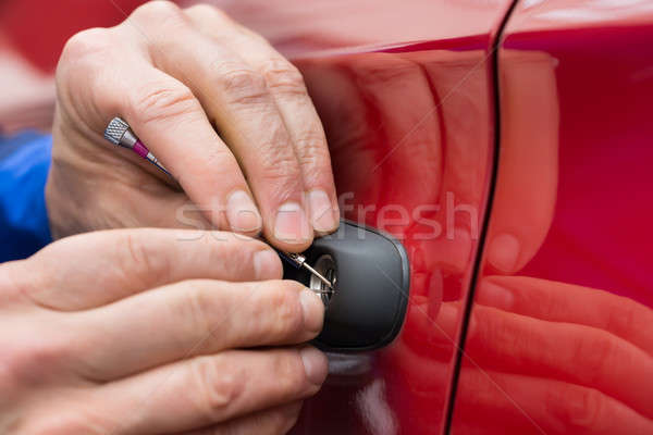 Stock photo: Hand Holding Lockpicker To Open Car Door