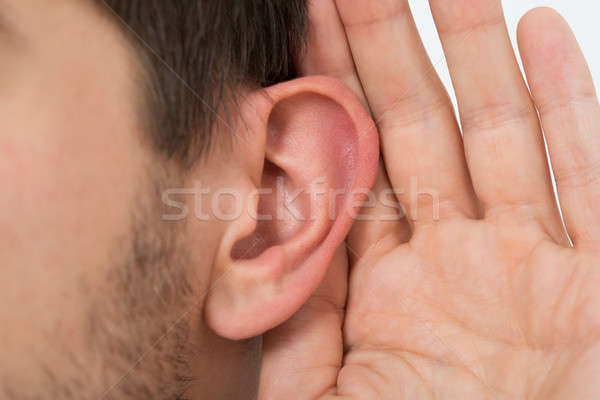 Person Trying To Hear With Hand Over Ear Stock photo © AndreyPopov