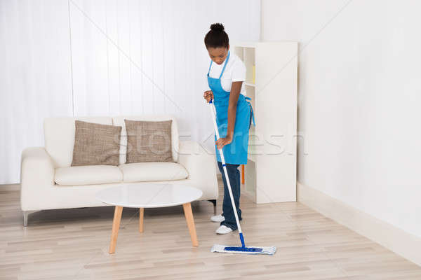 Stock photo: Female Janitor Mopping Floor