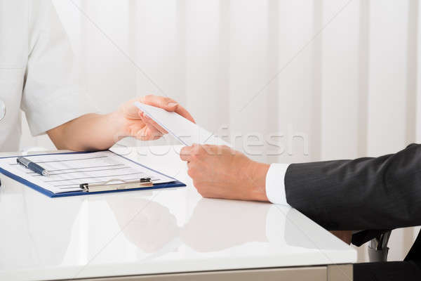 Doctor Hand Giving Prescription To Businessman Stock photo © AndreyPopov