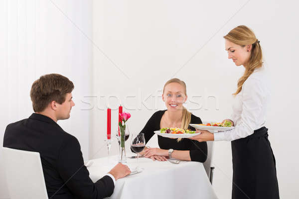 Waitress Serving Food To Couple Stock photo © AndreyPopov