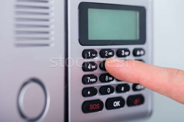 Person's Finger Setting Security Alarm Stock photo © AndreyPopov