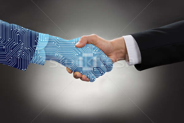 Stock photo: Digital Generated Human Hand And Business Man Shaking Hands