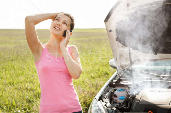 Woman Talking On Mobile Phone In Front Of Car Stock photo © AndreyPopov