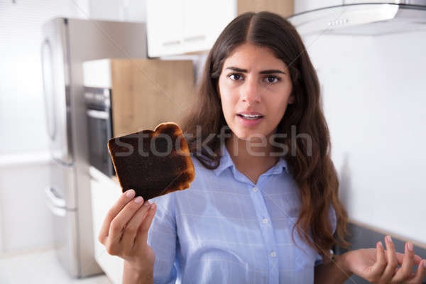 Sad Woman Looking At Burnt Toast Stock photo © AndreyPopov