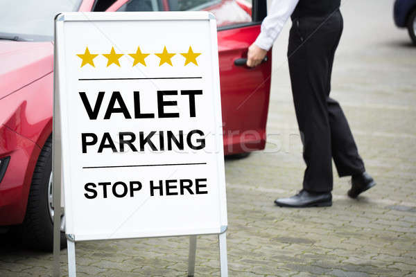 Young Male Valet Standing Near Valet Parking Sign Stock photo © AndreyPopov